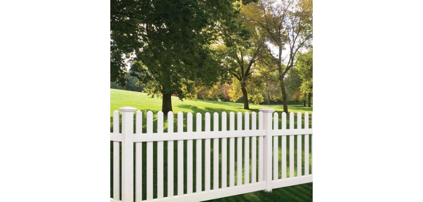 Vinyl Picket Fence installed in a yard near trees
