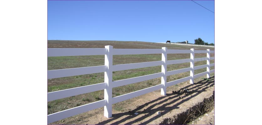White 4-rail vinyl fencing installed along a private road