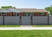 Gray gate and composite fencing installed in front yard