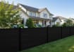 A row of Black NewStead Wood Plastic Composite Fencing with Black Posts 
