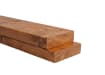 Western Red Cedar dimensional lumber beam – medium brown stained wood grain stacked timber close-up