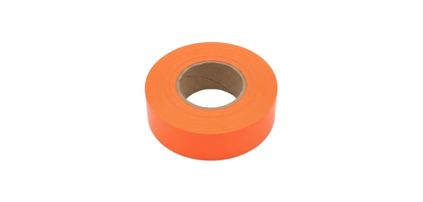 A roll of fluorescent orange flagging glow tape laying flat on a white background.