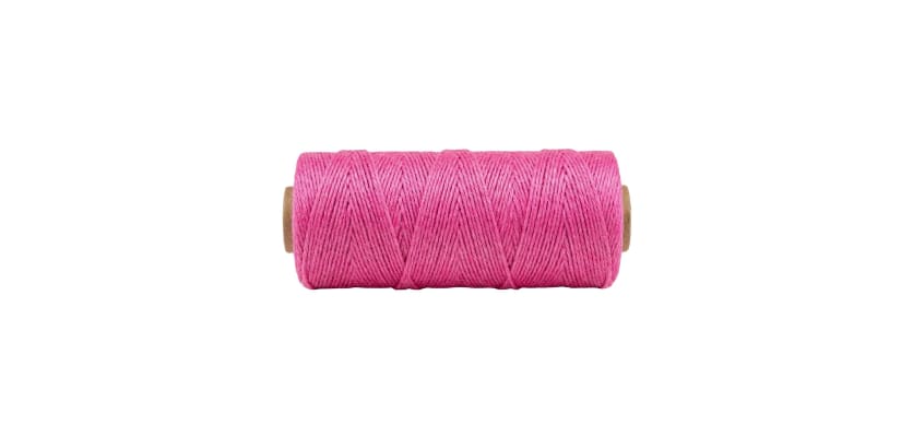 A spool of pink 18-gauge mason twine on a white background.